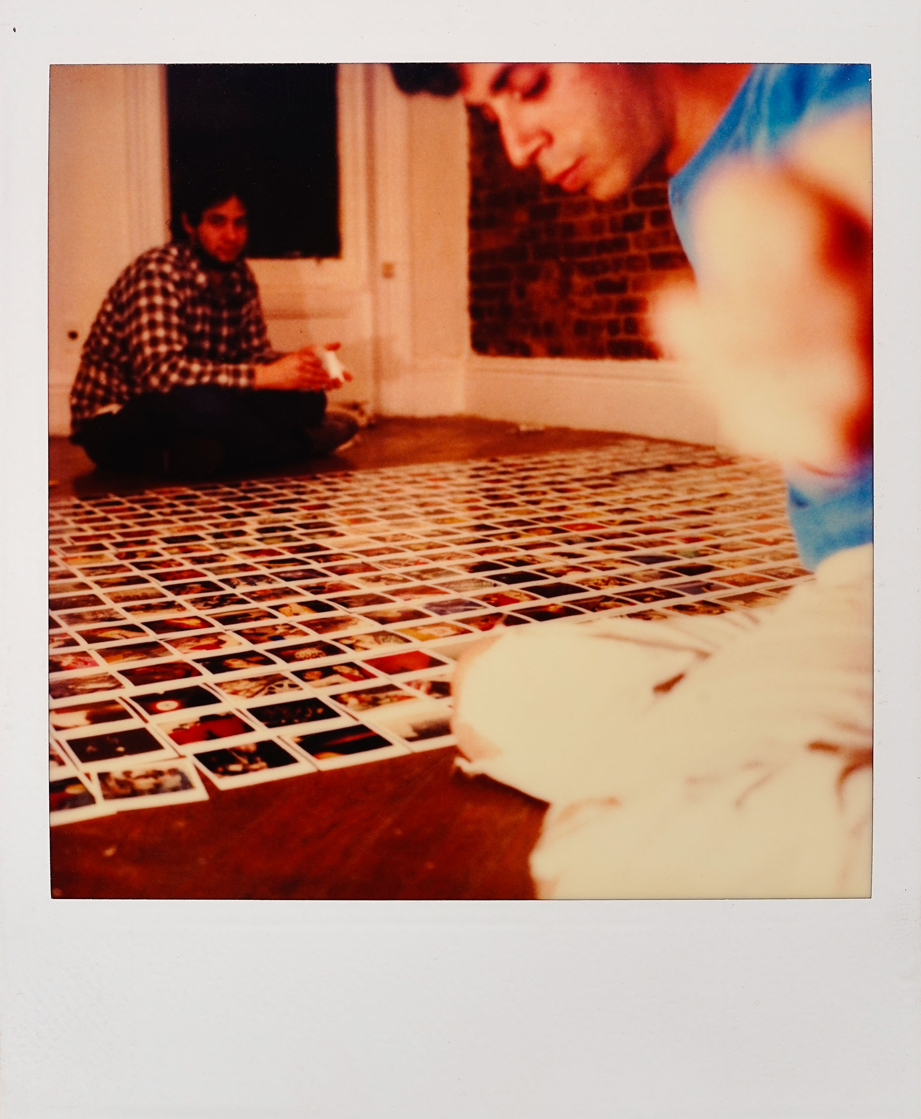 Jamie lays out Polaroids on the floor, March 31, 1983.
